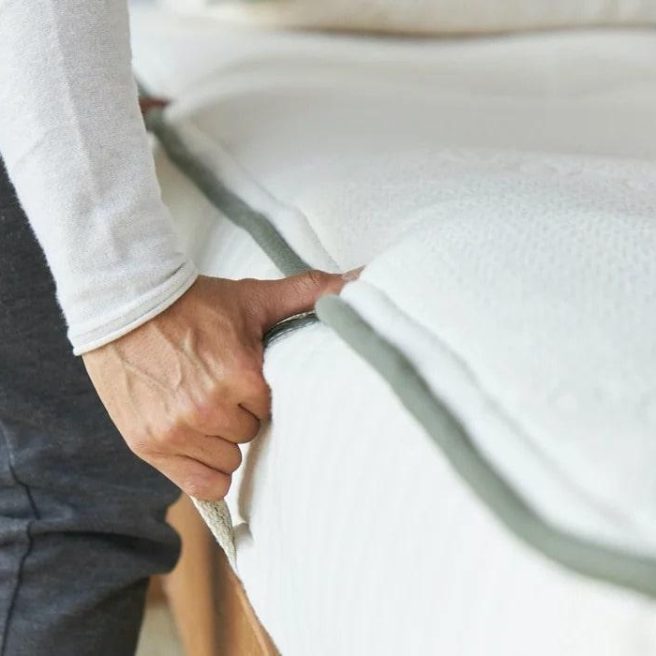 Two upholstered handles on each side of the Avocado Latex Mattress make moving or rotating it easier.